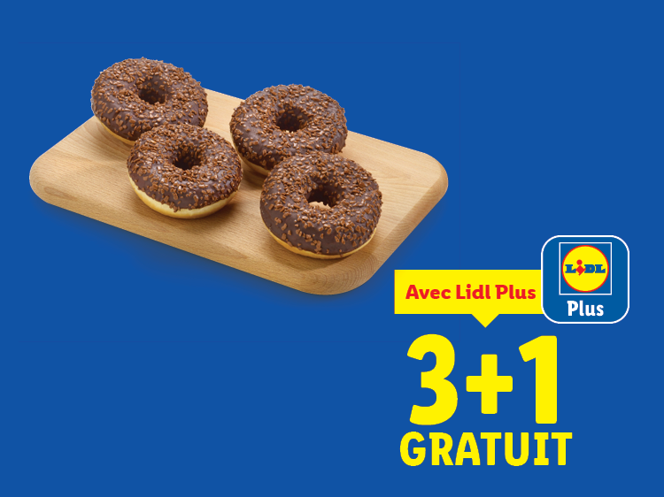 Quatre donuts au chocolat sur une planche en bois, avec une offre 3+1 gratuit.