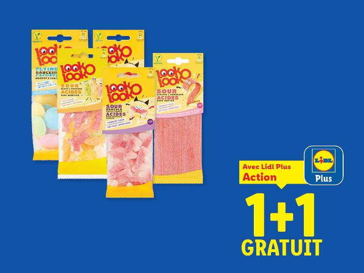 Sachets de bonbons acidulés variés, dont des soucoupes volantes et des lanières, avec offre 1+1 gratuit.