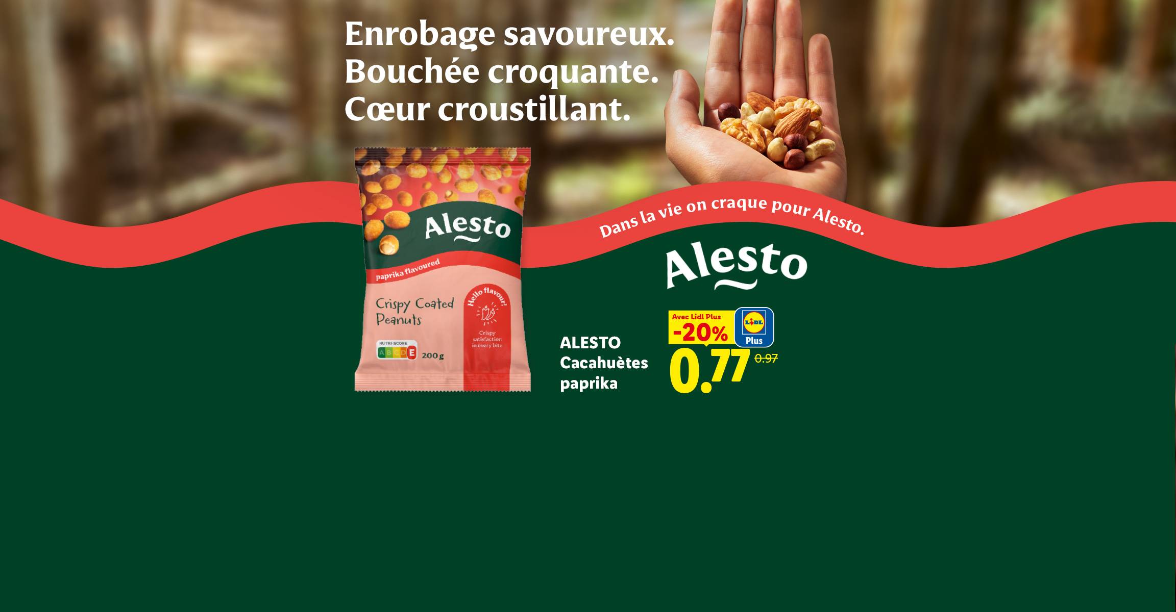 Publicité pour des cacahuètes enrobées de paprika, avec une main tenant un mélange de noix et le slogan 'Dans la vie on craque pour Alesto'.