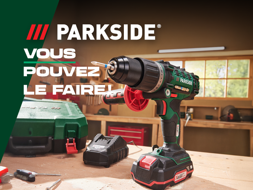 Perceuse sans fil Parkside sur un établi avec batterie et mallette.