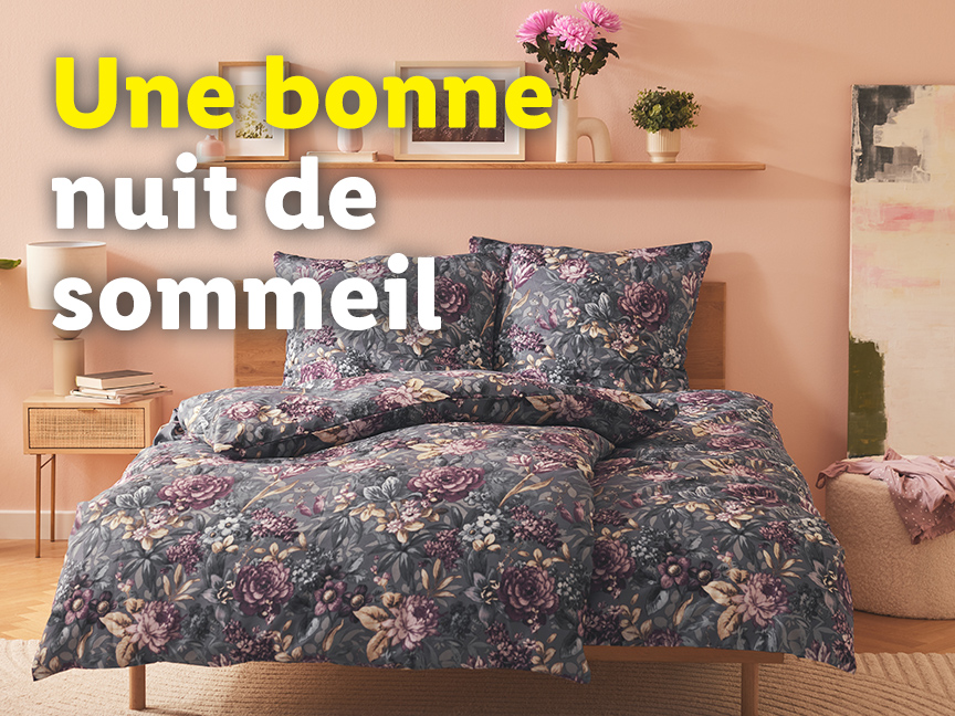Une literie fleurie grise pour une bonne nuit de sommeil.