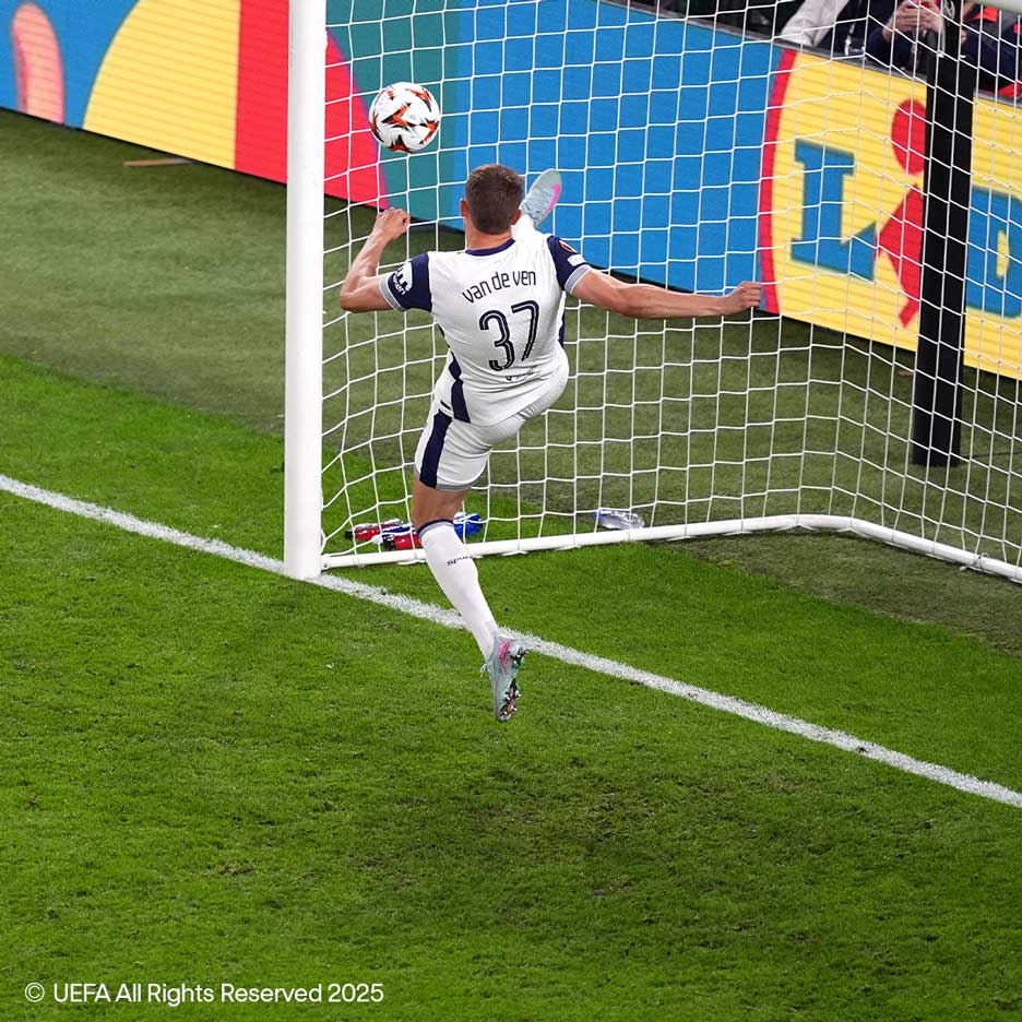 Footballeur en maillot blanc numéro 37 frappant le ballon vers le but.