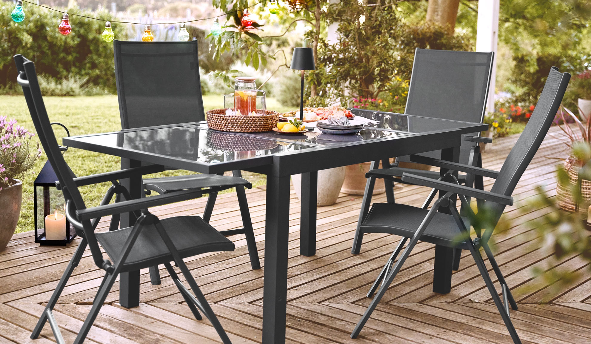 Table de jardin et chaises pliantes sur une terrasse.